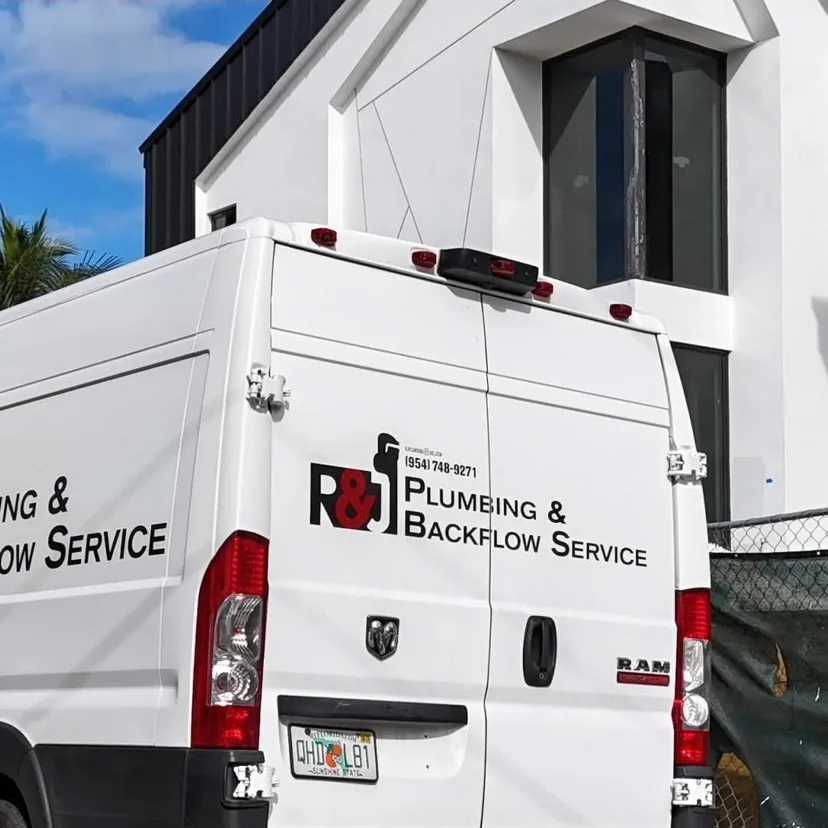 R&J Plumbing and Backflow Service van, rear livery with the phone number